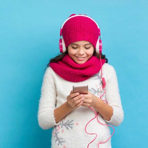 Front view little girl listening music