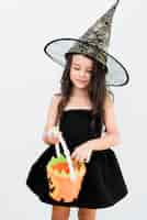 Free photo front view little girl in witch costume for halloween