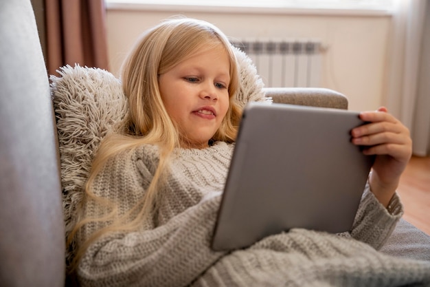 Front view of little girl with tablet