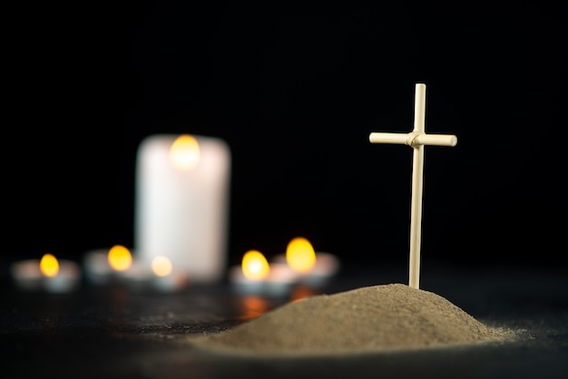 Free photo front view of little grave with candles on black