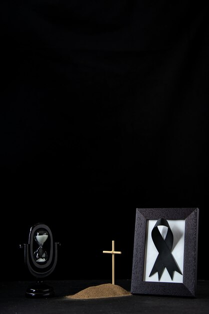 Front view of little grave with picture frame on black