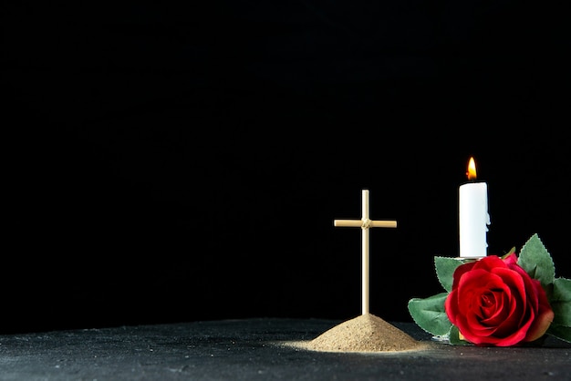 Front view of little grave with red flower on black