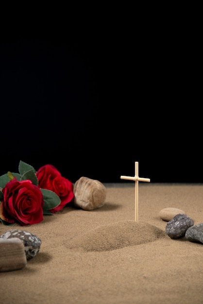 Vista frontale della piccola tomba con fiori rossi e pietre israele war
