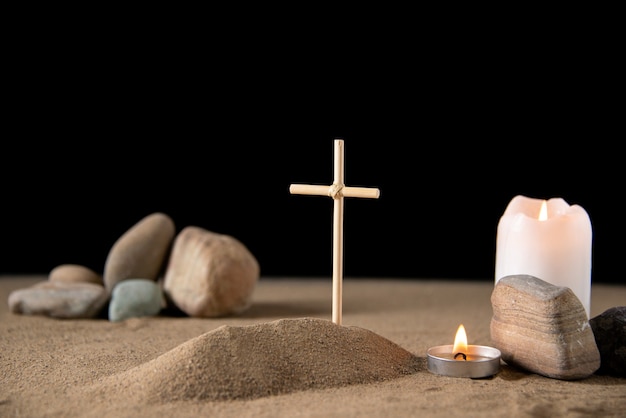 Free photo front view of little grave with stones on sand