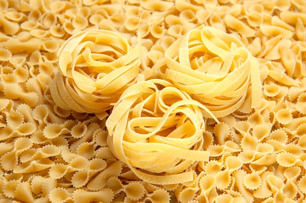 Front view little raw pasta on light many dough meal color photo food