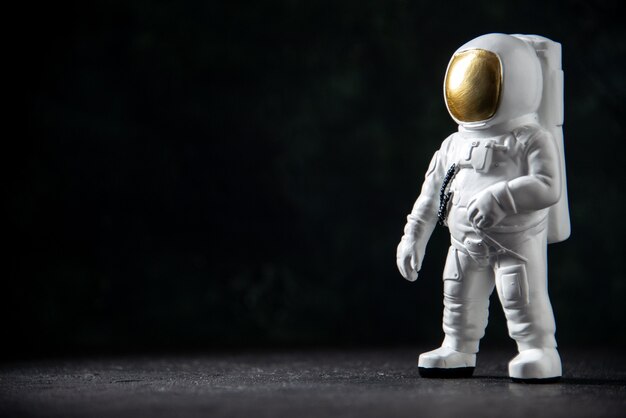 Front view of little spaceman toy on black