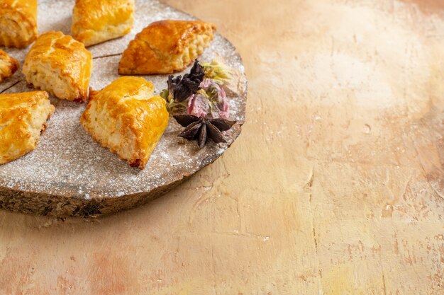 Front view little sweet pastries for tea on the light table sweet pie pastry cake