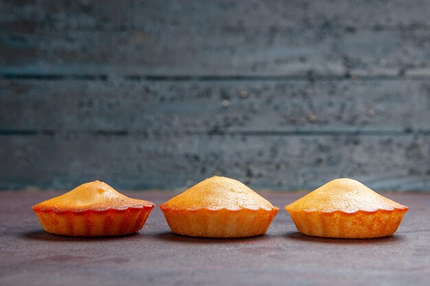 Front view little yummy cakes on dark background pie biscuit cake sweet cookie sugar tea