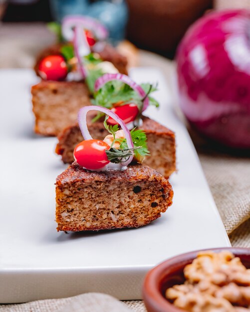 Front view liver pat with onion and cherry tomato