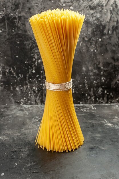 Front view long italian pasta raw on a light-grey food color dough cuisine photo meal