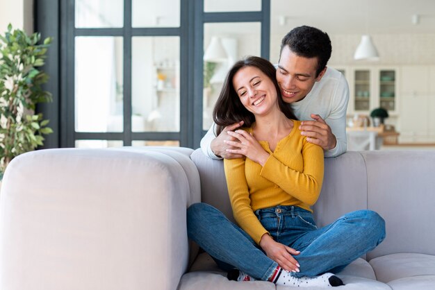 Front view of lovely couple on the sofa