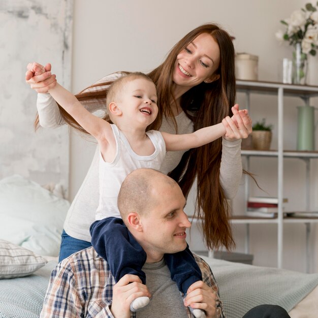 Front view of lovely parents with their kid