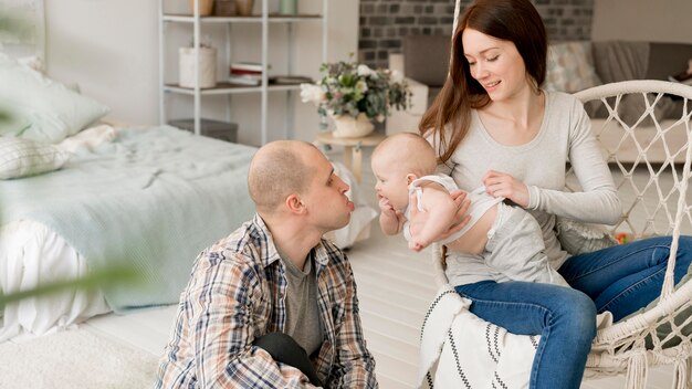 Front view of lovely parents with their kid