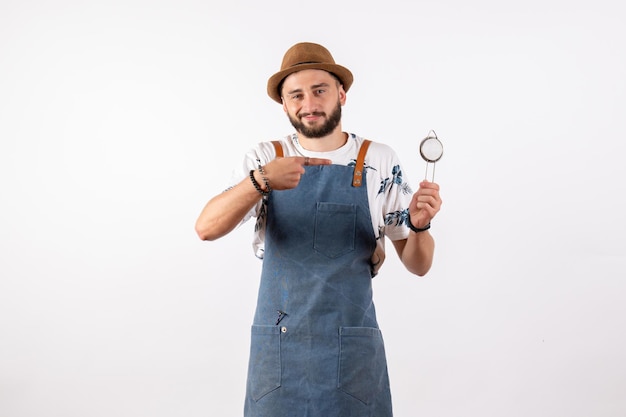 Front view male bartender holding nutcracker on white wall bar club night alcohol drink job model