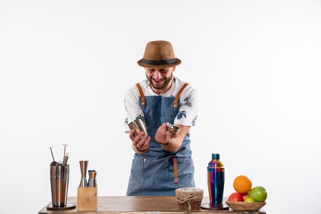 Front view male bartender holding shaker on light white wall job bar alcohol club night drink