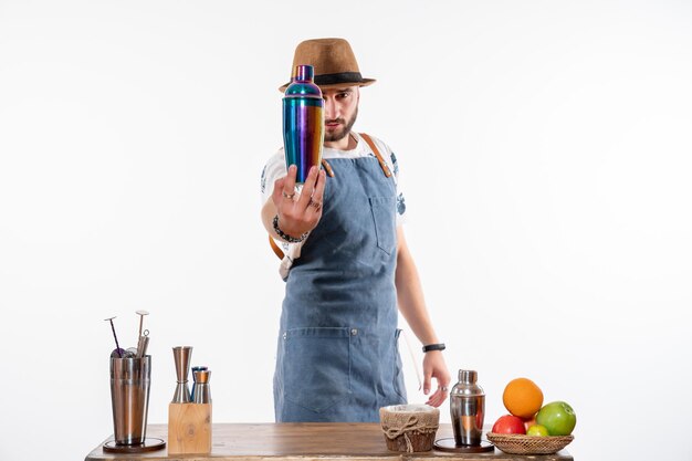 Front view male bartender holding shaker on white wall job bar alcohol club night drink