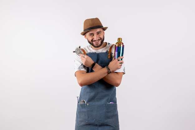 Front view male bartender holding shaker on white wall night job club alcohol color bar drinks