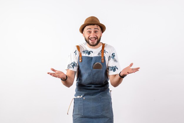 Front view male bartender posing with excited expression on white wall alcohol job night drink bar club