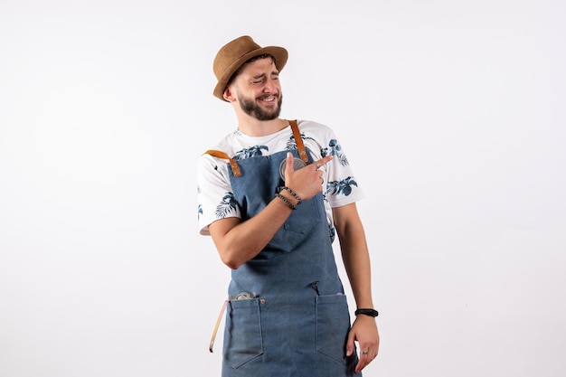 Front view male bartender posing with funny face on white wall alcohol job club night drink bar nut