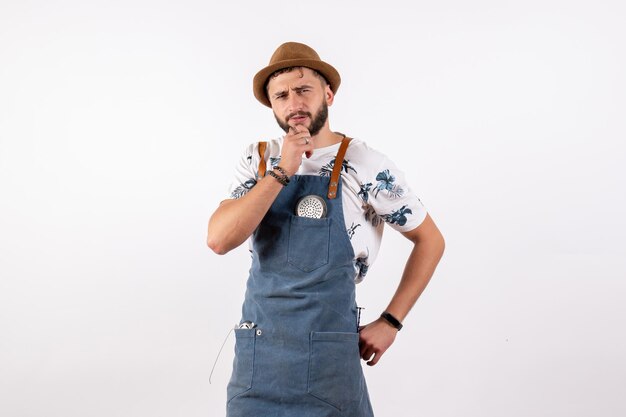 Front view male bartender posing with thinking expression on white wall alcohol job club night drink bar