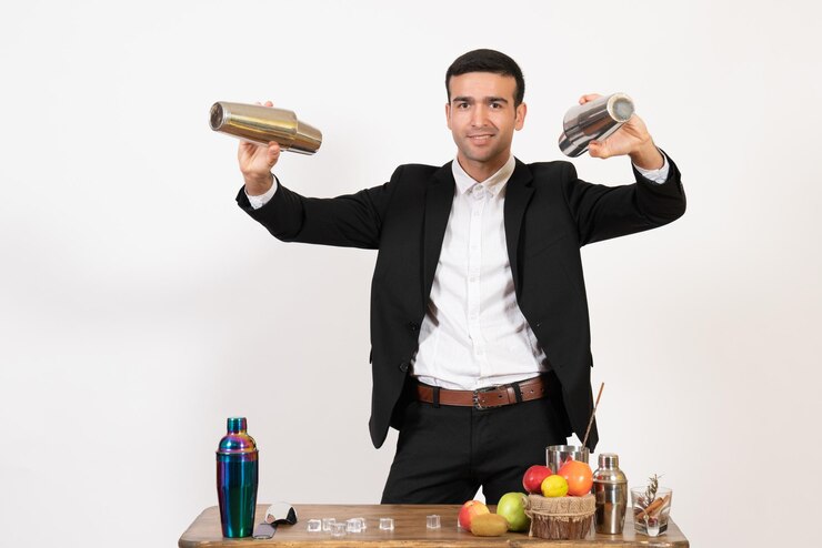 Free Photo front view male bartender in suit working with shakers and making drink on a white wall male night club dance drink bar