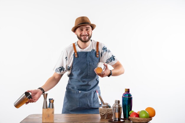 Front view male bartender working with shakers on a white wall job bar alcohol club night drink