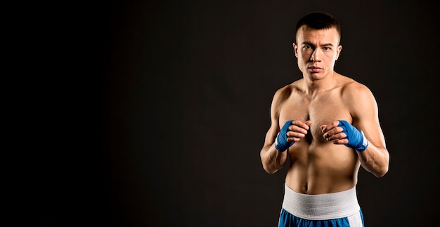 Free photo front view of male boxer with copy space