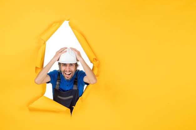 Free photo front view male builder in uniform on yellow background