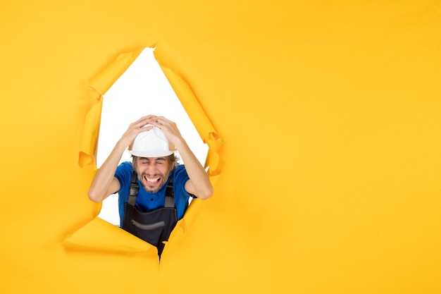 Front View Male Builder in Uniform on Yellow Background