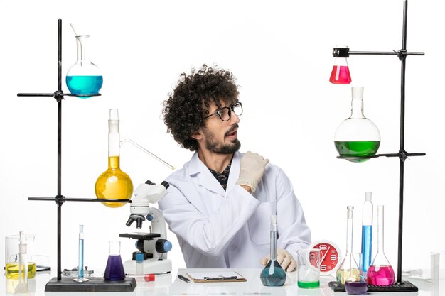 Front view male chemist in medical suit just sitting on white space