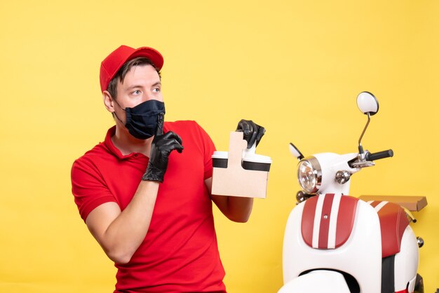 Front view male courier in black mask with coffee cups on yellow worker virus covid- service work delivery job