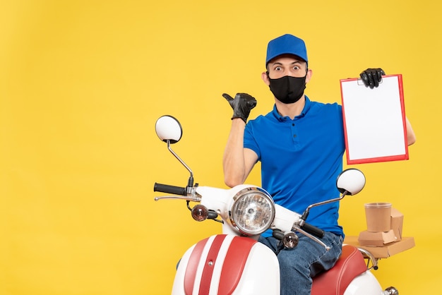 Free photo front view male courier in blue uniform with file note on yellow bike work covid- job virus delivery service pandemic