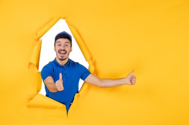 Front view male courier in blue uniform on a yellow space