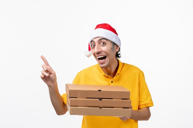 Front view male courier with pizza boxes on white wall service uniform delivery job