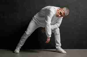 Free photo front view of male dancer posing in jeans and sneakers