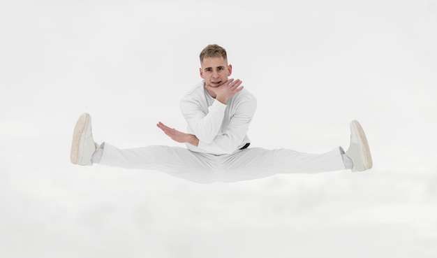 Free photo front view of male dancer posing in mid-air