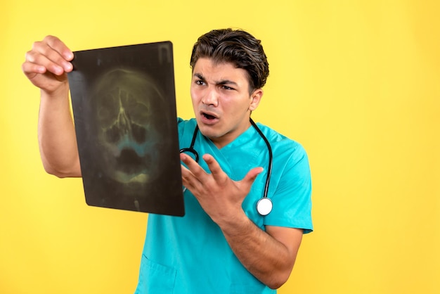 Front view of male doctor holding x-ray