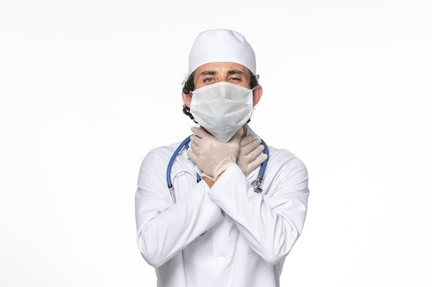 흰 벽 바이러스 스플래시 코로나 바이러스 전염병에 대한 covid-로부터 보호하기 위해 마스크와 의료 소송에서 전면보기 남성 의사