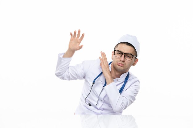 Front view male doctor in medical suit