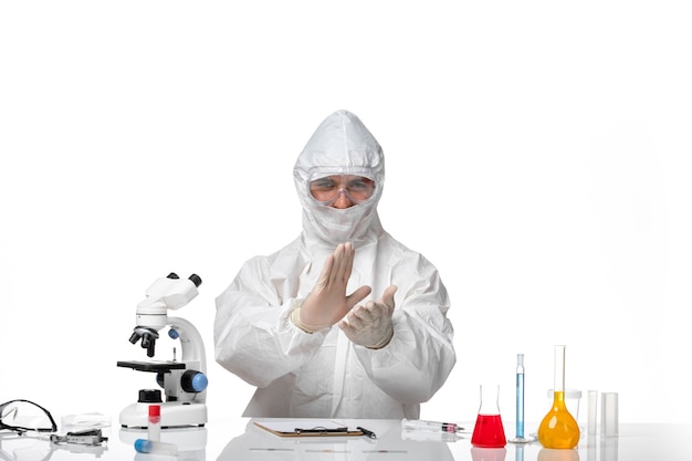 Front view male doctor in protective suit and with mask clapping on white space