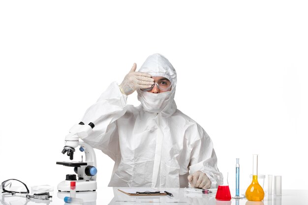 Front view male doctor in protective suit and with mask on white space