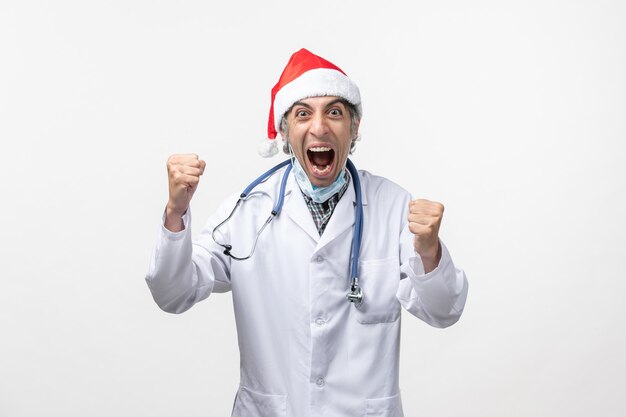 Front view male doctor screaming on white wall virus holiday covid emotion