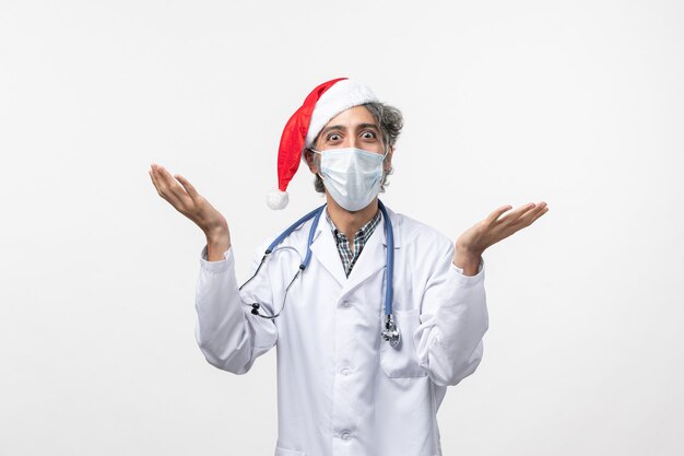 Front view male doctor in sterile mask on white floor virus covid new year holiday