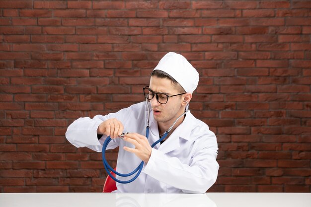 Front view male doctor in white medical suit with stethoscope