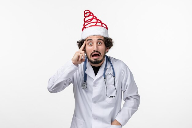 Free photo front view of male doctor on a white wall