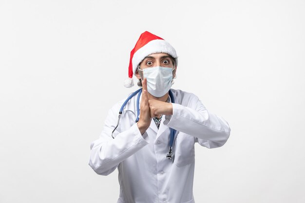 Front view male doctor with mask on white wall virus holiday pandemic covid