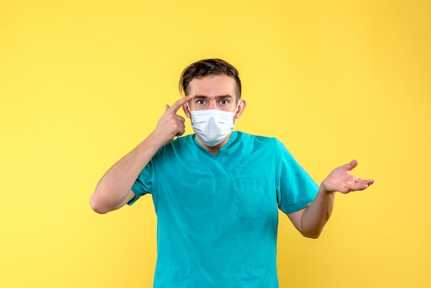 Free photo front view of male doctor on yellow wall