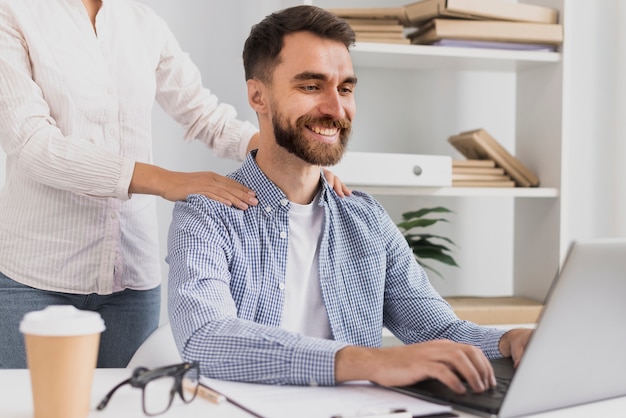 Free photo front view male employee having a massage