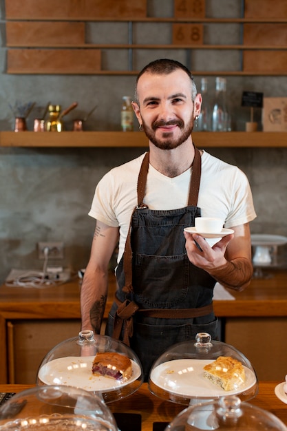 Front view male employee serving coffee