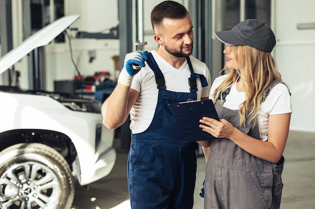 Free photo front view male and female mechanics